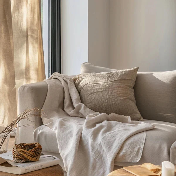 Oak & Linen Throw Blanket draped over sofa in neutral living room
